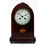 An Edwardian mahogany boxwood strung lancet top mantel clock, inlaid with a fan paterae oval,