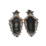 A pair of Italian faience framed mirrors, 19th century, of cartouche shape,