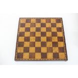 A Victorian rosewood and satinwood games board with barber's pole bandings,