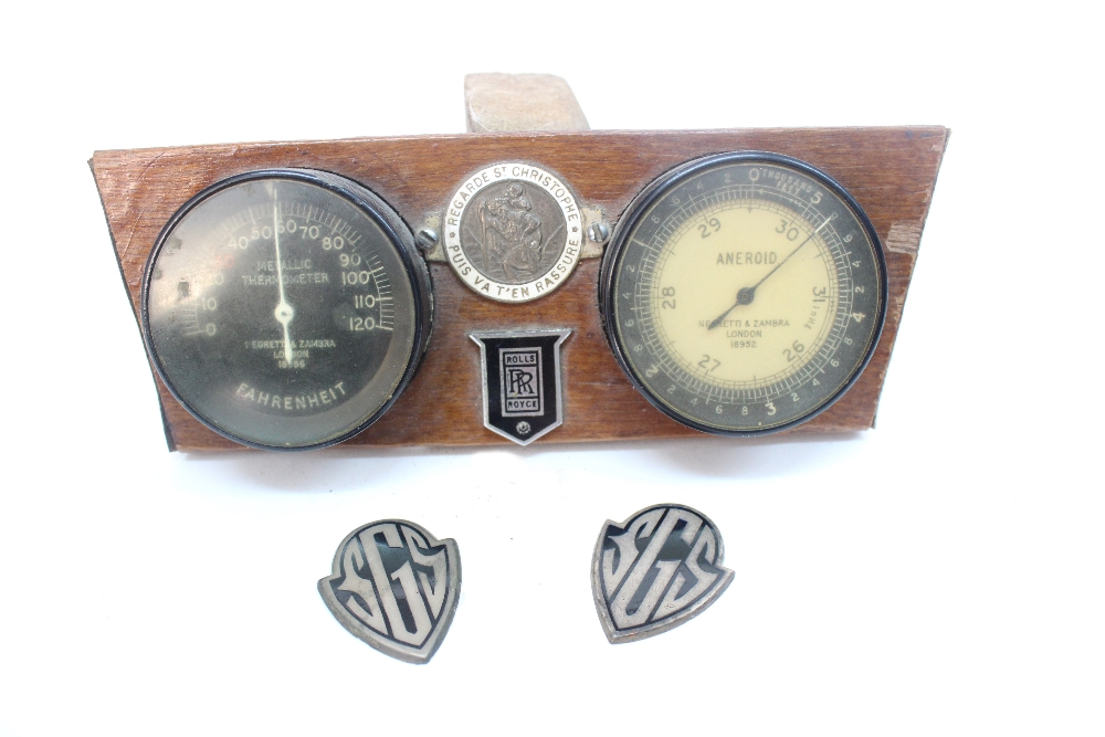 A Negretti & Zambra metallic thermometer and aneroid mounted as part of a motor car dash board with