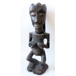 An African carving of a nude female, possibly from Zaire,