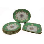 A Minton porcelain nine piece dessert service, centrally painted with a bouquet of flowers,