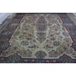 A Kirman carpet, the ivory field with floral central medallion and border, 430 x 306cm.