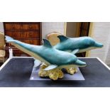 A modern polychrome bronze sculpture, cast with two dolphins atop a naturalistic base, 123cm wide.