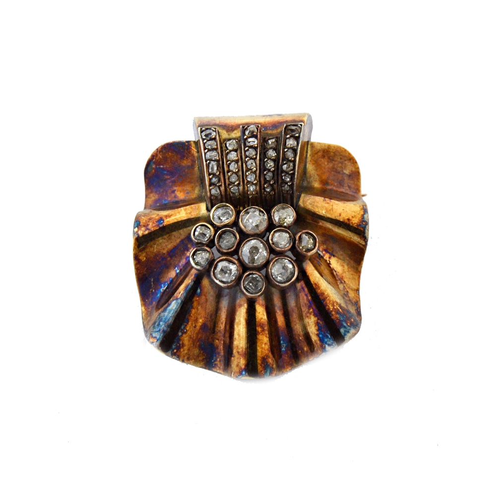 A gold and diamond brooch, in a fanned and ridged design, in the Art Deco taste,