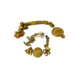 A collection of African Ashanti gold amulets or beads, in a variety of designs,