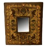 A crewel work rectangular mirror frame, 17th/18th century, with central armorial crest,