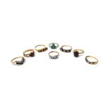 Six mostly 9ct gold and gem set rings, to include; a garnet seven stone cluster ring, London 1975,