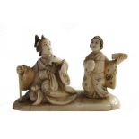 A small Japanese ivory carving of a seated woman and attendant, late 19th century, 4.25cm.