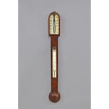 A Victorian walnut stick barometer By Dollond, London The trunk with an arched top,