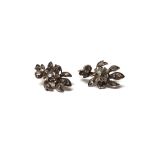 A pair of rose diamond set earrings, each in a stylized floral design,