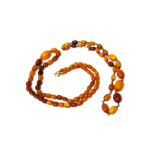 Two single row necklaces of graduated vary coloured butterscotch coloured amber beads,