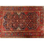 A Malayer rug, Persian, the indigo field with an intricate herate design, shaped surround,