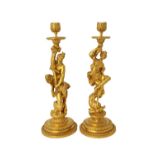 A pair of French ormolu candlesticks, late 19th century, in the manner of Corneille Van Cleve,