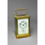 A French brass carriage clock Circa 1900 The Corniche case with cream enamel dial,