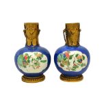 A pair of Chinese gilt-metal mounted famille-verte bottles, the porcelain Kangxi,