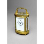 A French oval miniature brass carriage timepiece Late 20th century With white enamel dial and