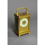 A French brass carriage timepiece Circa 1900 The case with a shaped handle,