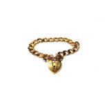 A 9ct gold faceted curb link bracelet, with a 9ct gold heart shaped padlock clasp, weight 22.4 gms.