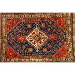 A Ghasghai rug, South Persian, the indigo field with a stepped ivory medallion, minor flower motifs,