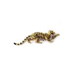 A gold and enamelled brooch, modelled as a tiger, the eyes mounted with circular cut diamonds,