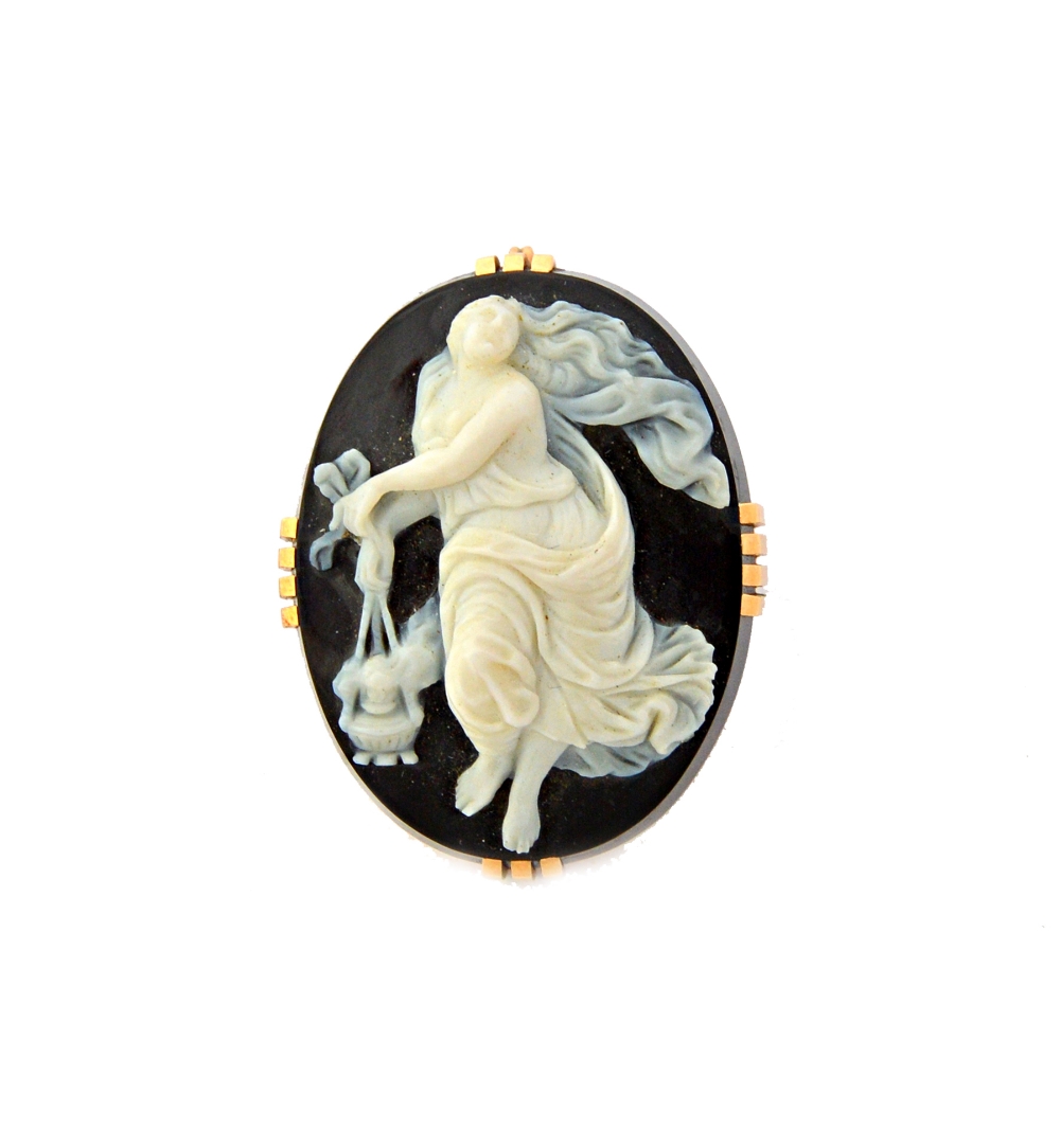 A gold mounted oval banded agate cameo brooch, carved as the figure of a classical lady,
