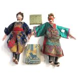 A pair of Chinese dolls, late 19th/20th, each as a male with plaster head and hands,