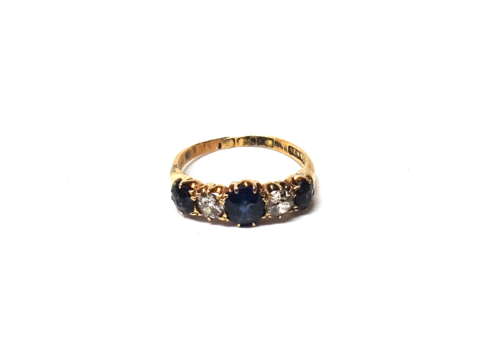 An 18ct gold, sapphire and diamond three stone ring,