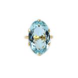 A gold ring, claw set with a large oval cut aquamarine, detailed 18 CT, ring size N and a half.