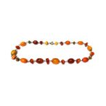 A single row necklace of amber, simulated amber and other beads,