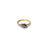 A gold and platinum, diamond set three stone ring, mounted with a row of circular cut diamonds,