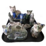 A group of nine Qajar pottery animals, late 19th/early 20th century, comprising; five cats,