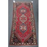 A Ghasghai rug, Persian, the madder field with three medallions, flowers,