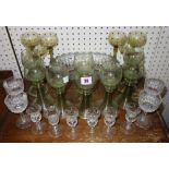 A set of eight etched green dining glasses, four small cut glasses and two sets of six glasses.