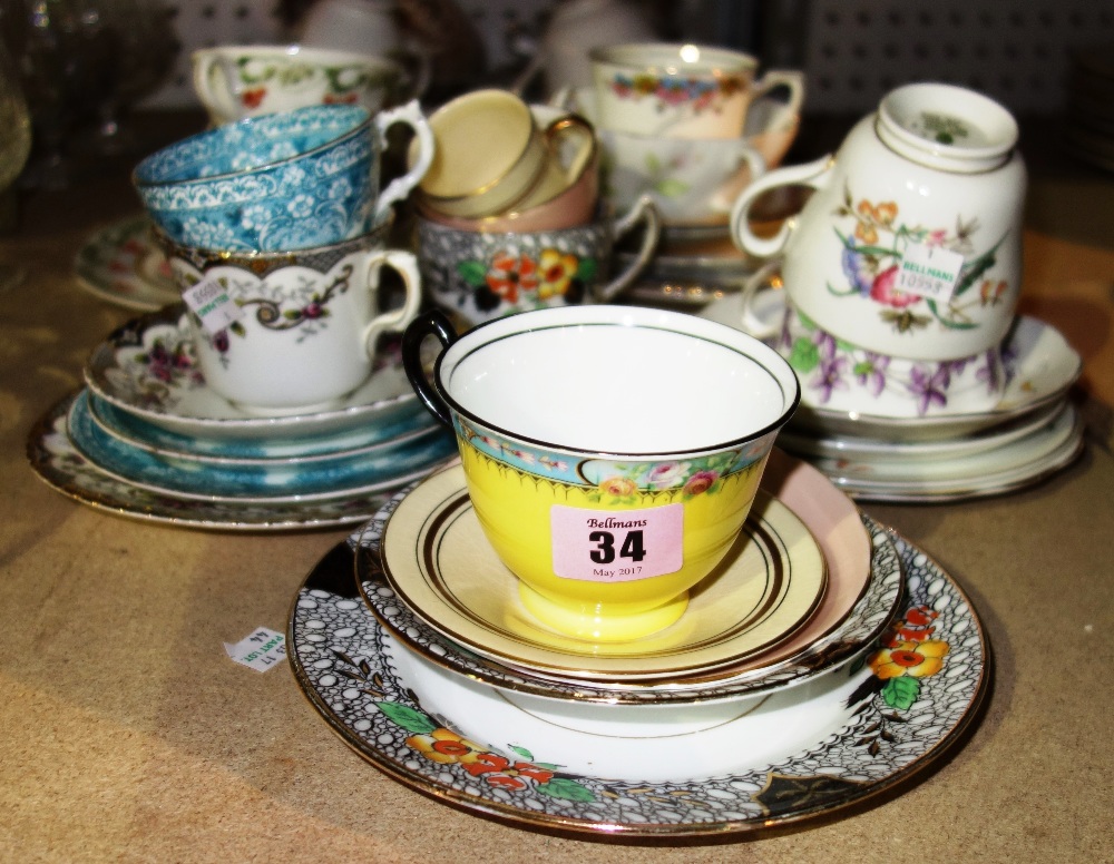 A quantity of ceramic trios and cup and saucer sets.