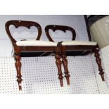 A pair of Victorian mahogany framed spoon back dining chairs on turned supports.