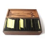 Forty-nine Victorian glass slides in a wooden case relating to the Britten,