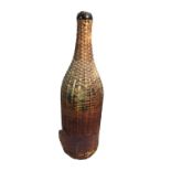 A large glass and wicker eau de cologne bottle, bears label 'Genuine Eau de Cologne, Francais,