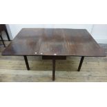 A George III mahogany dining table, with hinged deep drop leaves, on moulded square chamfered legs,