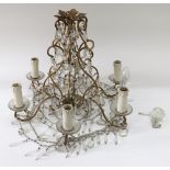 A gilt metal and cut glass six light chandelier, 20th century, with scrolling branches,