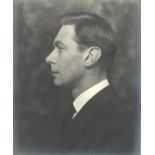 A framed photograph of George VI in profile by Bertram Paul,