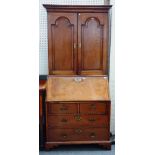 A mid-18th century mahogany bureau bookcase, the pair of arched panel doors over fitted interior,