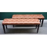 A pair of rectangular mahogany footstools, with buttoned tan leather tops,