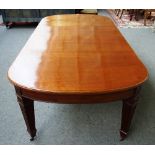 A 19th century extending dining table on channelled tapering square supports,