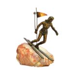 A Curtis Jere bronze skier, circa 1970, mounted atop a rock, signed 28cm high.