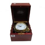 A modern Mathew Norman gimble mounted brass clock, housed in a polished mahogany case.