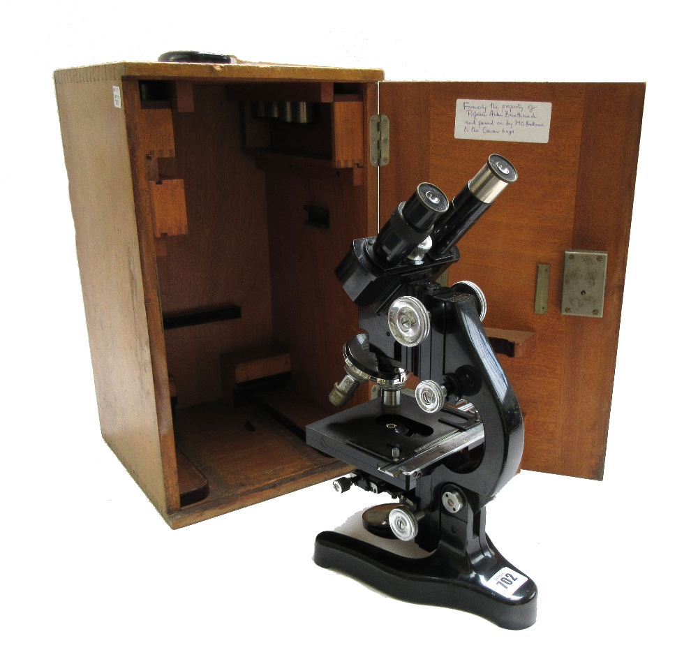 A Leitz Wetzlar black lacquered brass binocular microscope, circa 1950, in a fitted case.