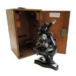 A Leitz Wetzlar black lacquered brass binocular microscope, circa 1950, in a fitted case.