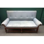 An Arts & Crafts mahogany framed square back sofa with roll over arms,