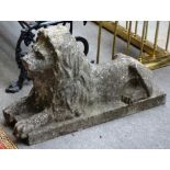 A pair of reconstituted stone hollow cast models of recumbent lions, on rectangular bases,